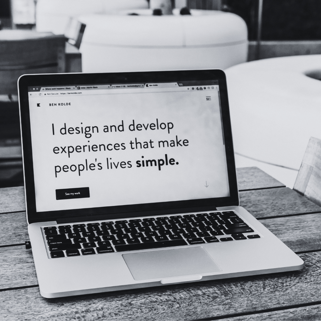 Mac laptop with the text 'I design and develop experiences that make people's lives simple'.